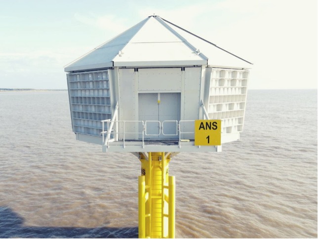 A yellow platform structure marked "ANS 1" rises from the water, featuring a hexagonal building with a sloped roof.